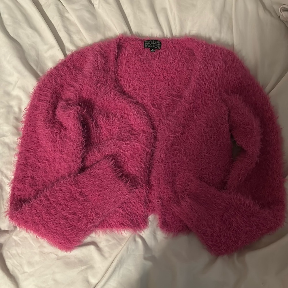 Hi, I am selling a cropped, fluffy pink cardigan.